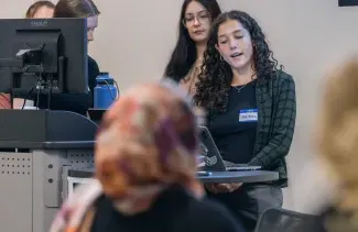 A group of students gives a slideshow presentation